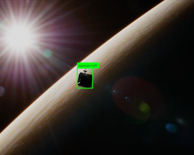 The silhouette of a spacecraft against reflected light from the Earth, with a green box around it indicating an object detection annotation.